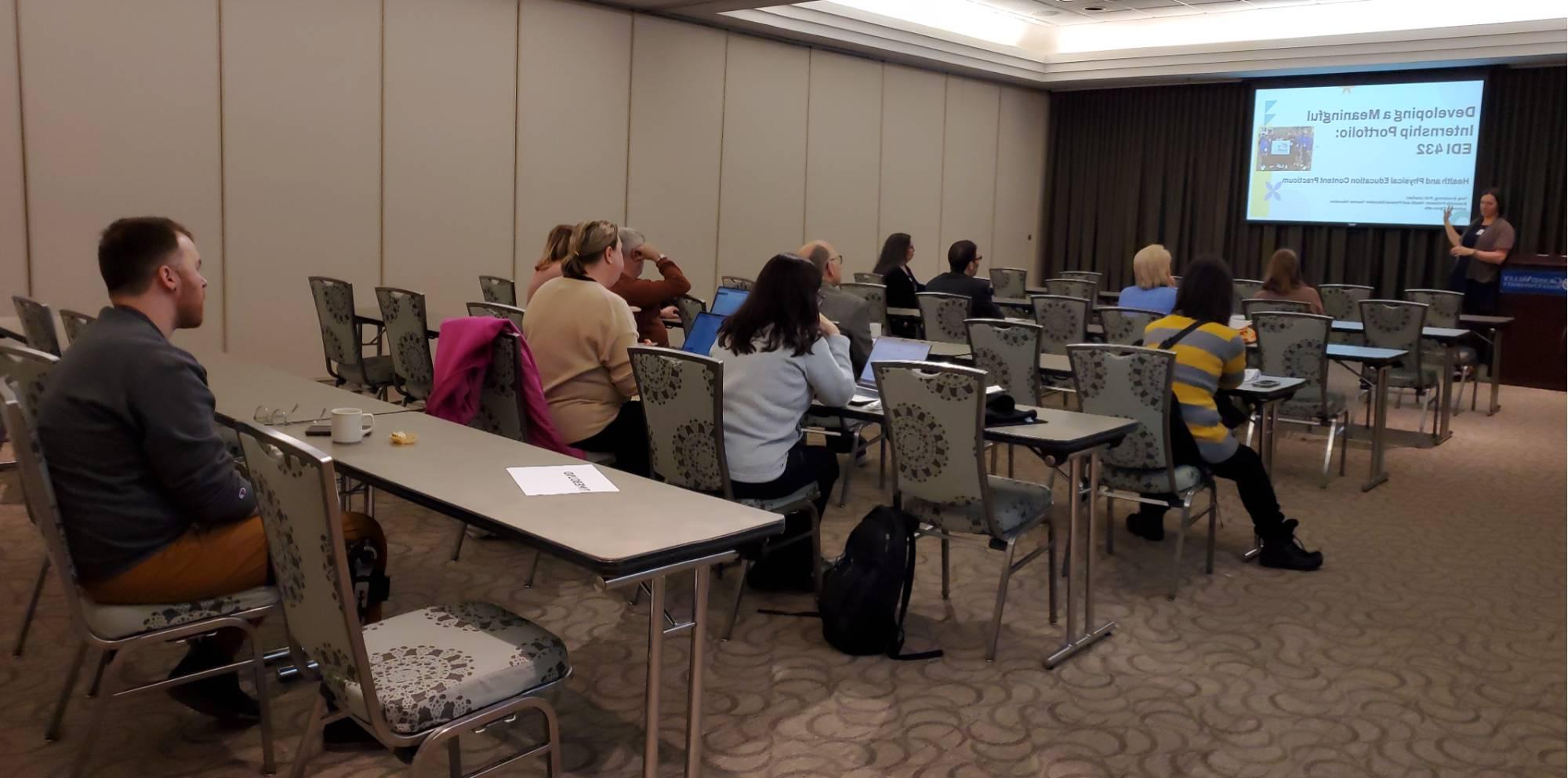 Attendees listen attentively to Tess Armstrong's presentation